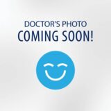 An abstract silhouette with a light blue background and bold text stating "COMING SOON." The image suggests that content or a profile will be available in the future.